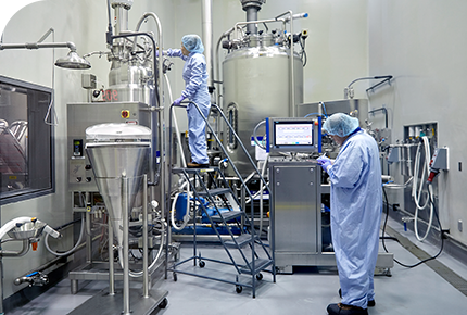 A technology transfer engineer working inside a pharmaceutical process development facility